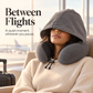 Adult traveler resting with a dark gray hooded neck pillow in a bright airport lounge