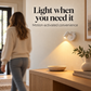 White motion sensor wall light illuminating an indoor hallway