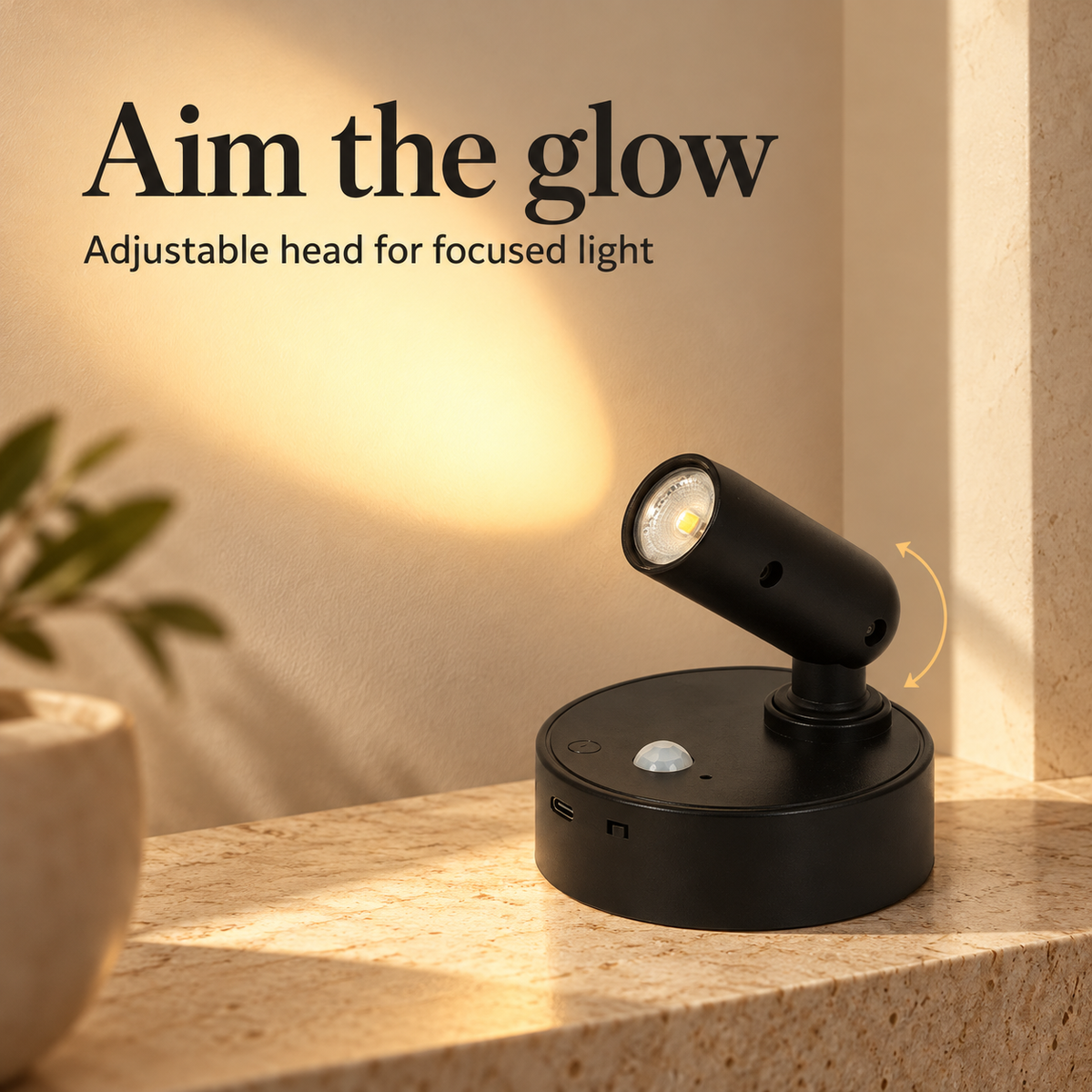 Adjustable black spotlight head directing warm light onto a shelf